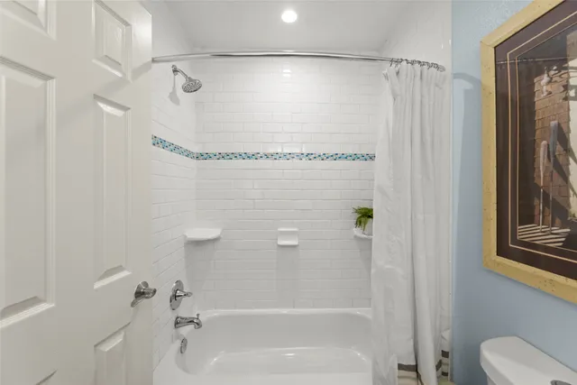 a bathroom with a shower and a bath tub