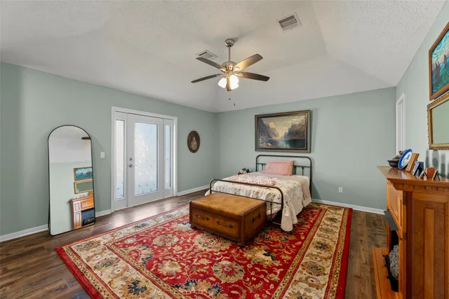 a bedroom with furniture and a rug