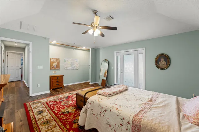 a bedroom with a large bed and a chandelier