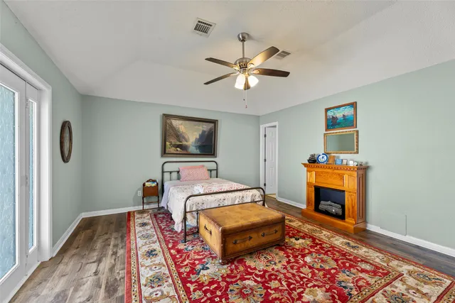 a bedroom with a bed and wooden floor