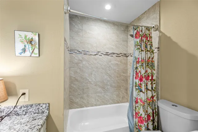 a bathroom with a shower and a sink