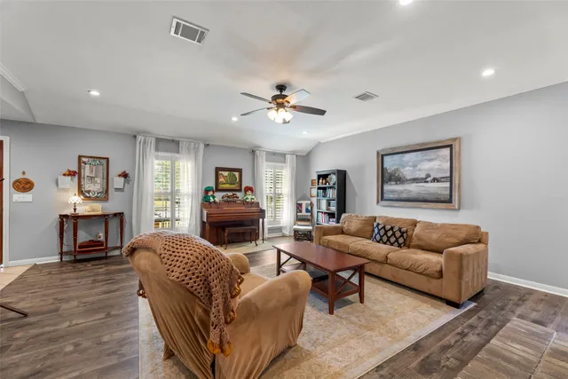 a living room with furniture flat screen tv and a fireplace