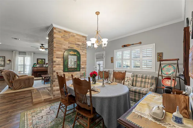 a view of a dining room with furniture wooden floor and chandelier