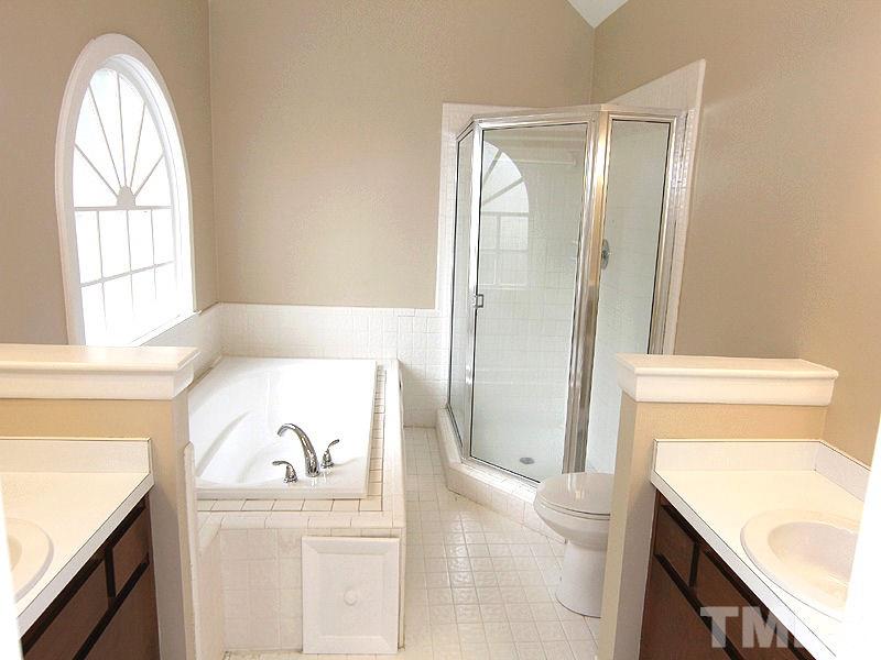 8333 Apple Orchard Way Raleigh, NC 27615 - Photo 16 of 25 a bathroom with a bathtub and a sink