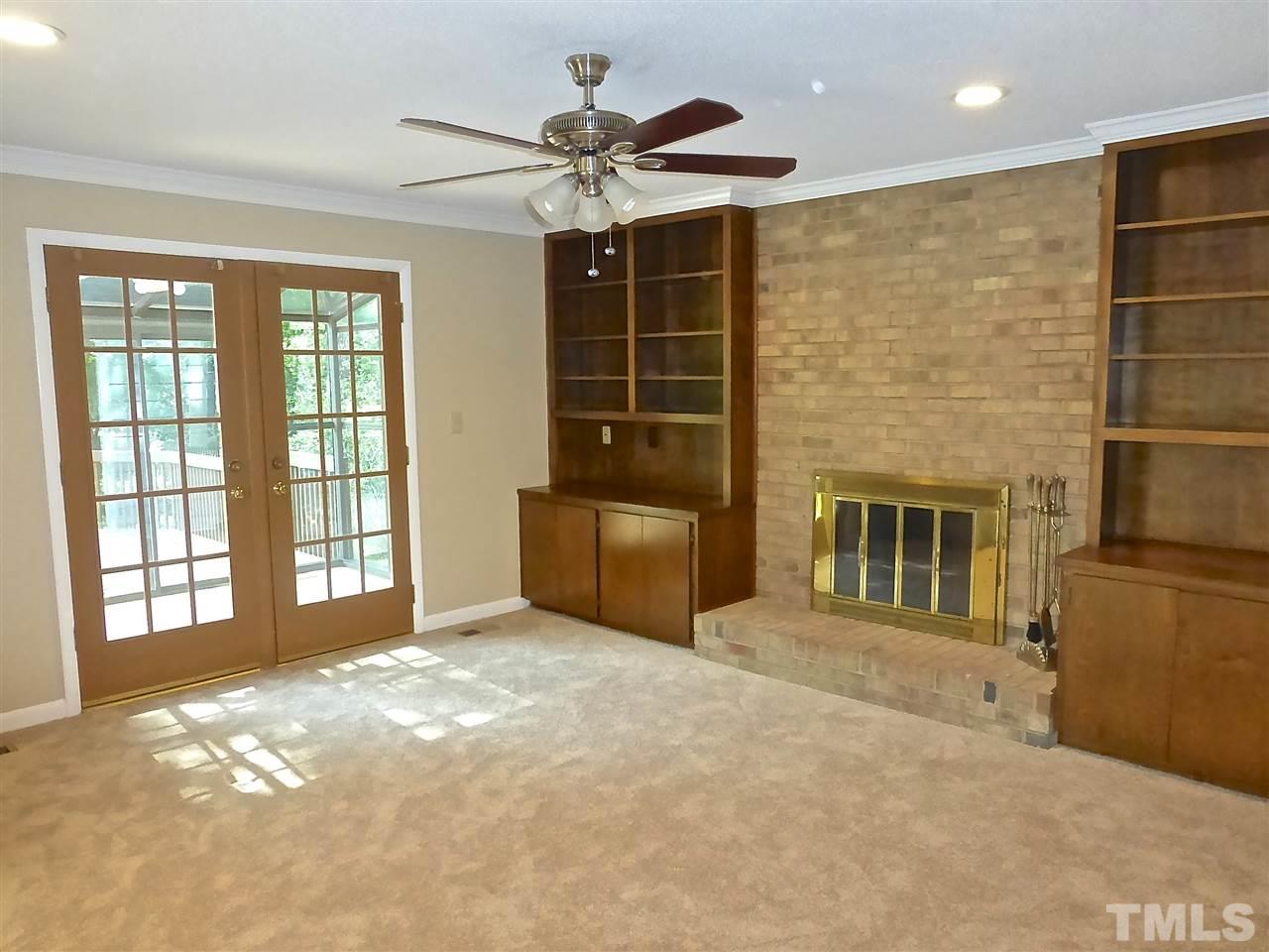 8333 Apple Orchard Way Raleigh, NC 27615 - Photo 17 of 25 a living room with a large window and chandelier