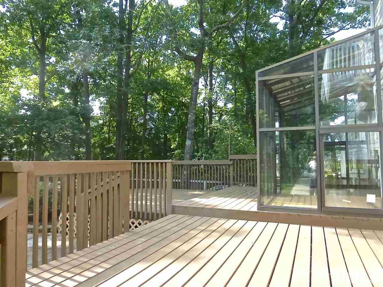 8333 Apple Orchard Way Raleigh, NC 27615 - Photo 22 of 25 a view of backyard with a deck and wooden floor