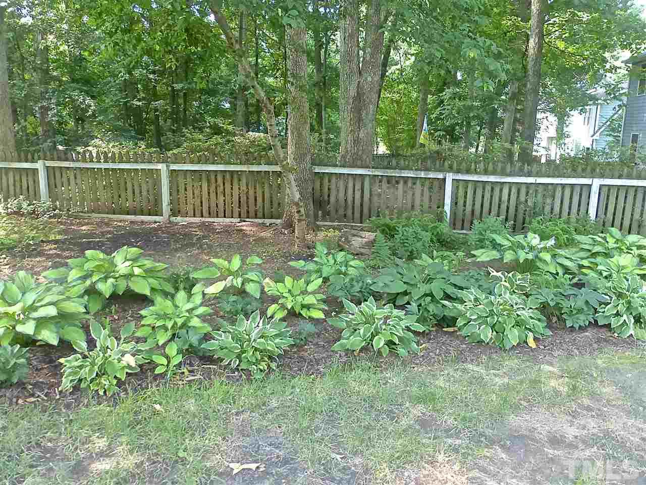 8333 Apple Orchard Way Raleigh, NC 27615 - Photo 24 of 25 a view of a garden with wooden fence