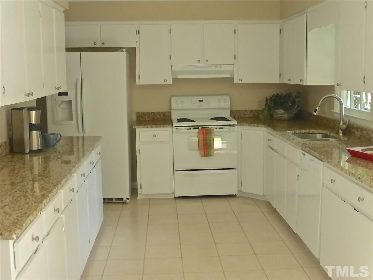 8333 Apple Orchard Way Raleigh, NC 27615 - Photo 10 of 25 a kitchen with a sink stove and cabinets