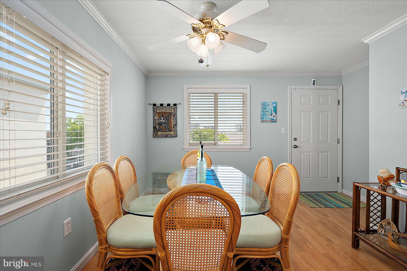 11603 Seaward Road, Unit 6 Ocean City, MD 21842 - Photo 13 of 43 a dining room with furniture a chandelier and wooden floor