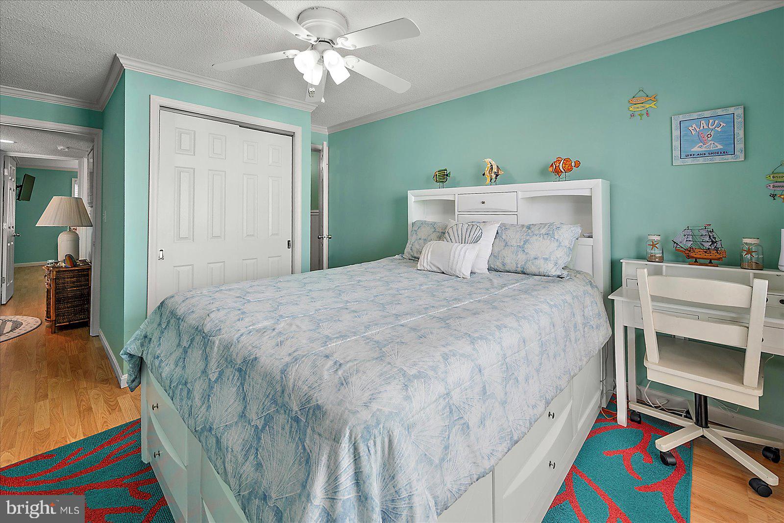 11603 Seaward Road, Unit 6 Ocean City, MD 21842 - Photo 16 of 43 a bedroom with a bed and a chandelier