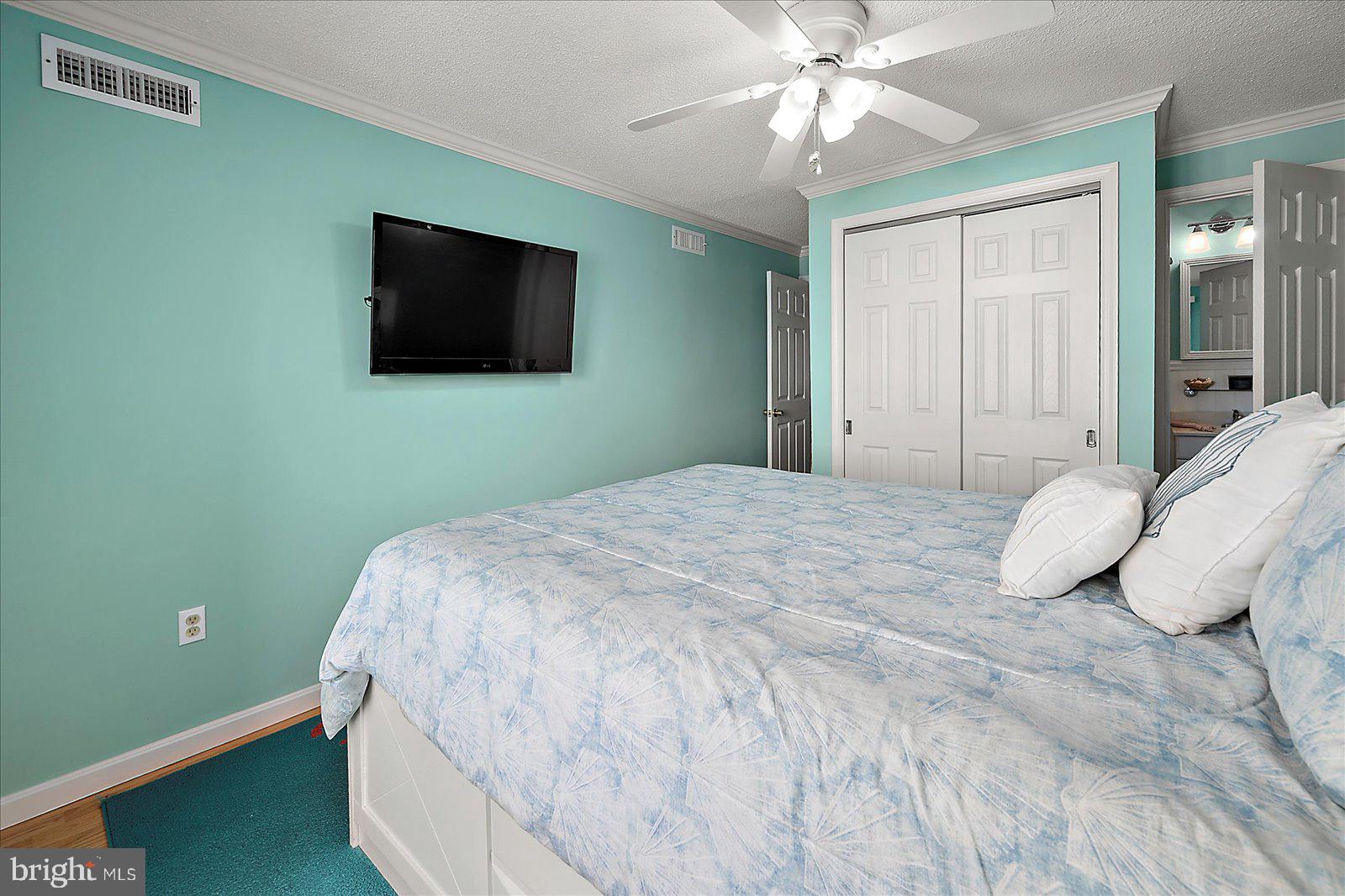 11603 Seaward Road, Unit 6 Ocean City, MD 21842 - Photo 17 of 43 a bedroom with a bed and a flat screen tv