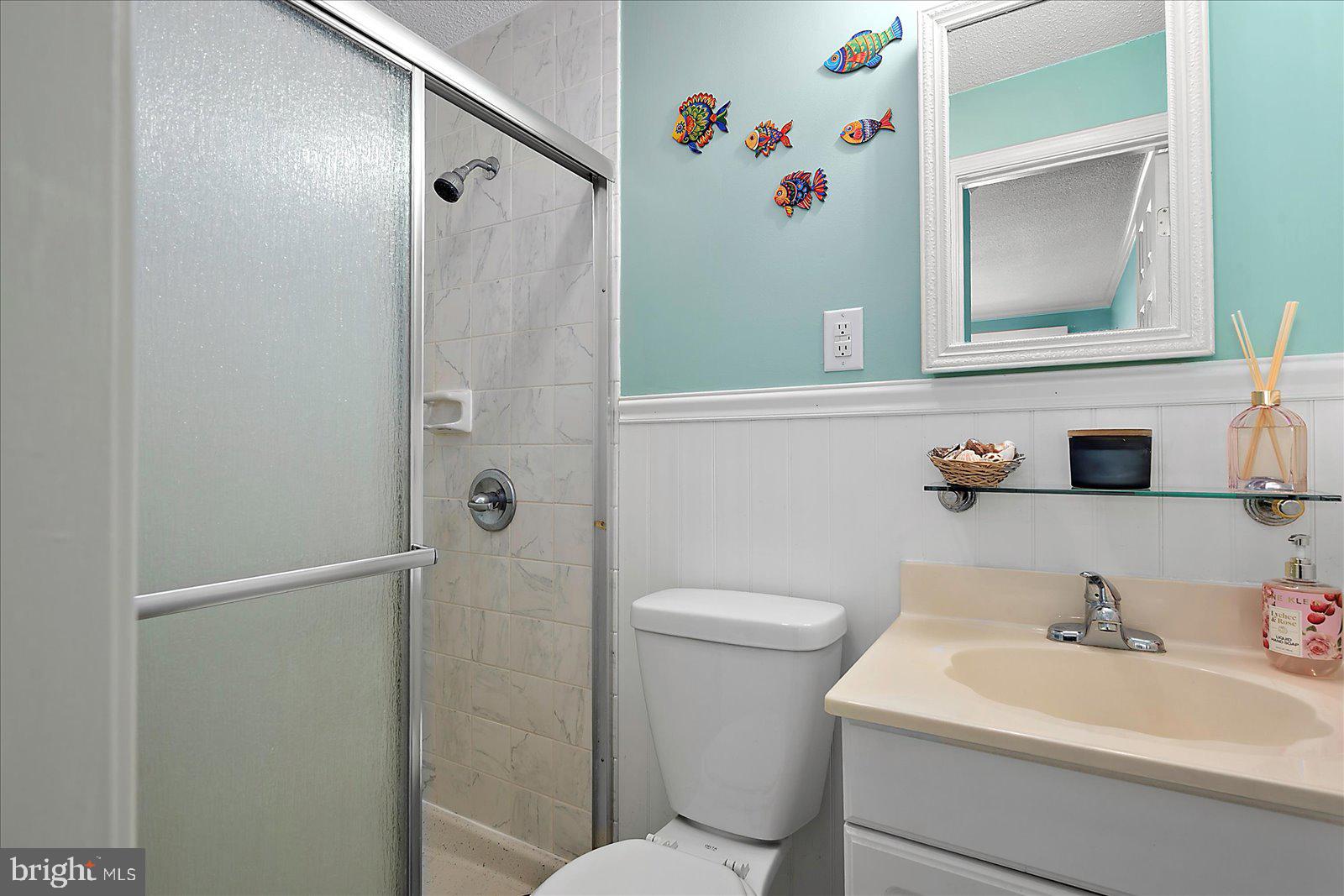 11603 Seaward Road, Unit 6 Ocean City, MD 21842 - Photo 19 of 43 a bathroom with a sink toilet and vanity