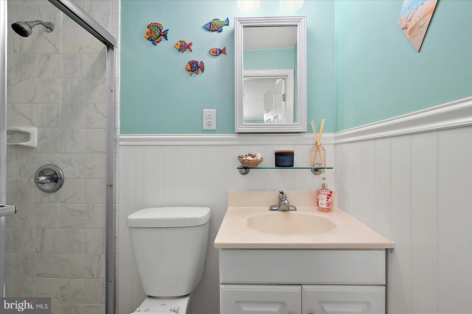 11603 Seaward Road, Unit 6 Ocean City, MD 21842 - Photo 20 of 43 a bathroom with a sink a toilet and shower curtain