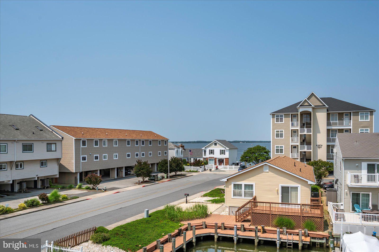11603 Seaward Road, Unit 6 Ocean City, MD 21842 - Photo 28 of 43 a front view of a residential apartment building with a yard