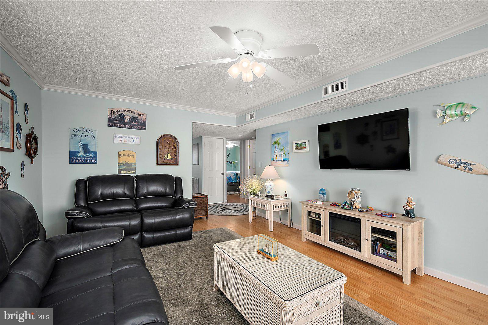 11603 Seaward Road, Unit 6 Ocean City, MD 21842 - Photo 6 of 43 a living room with furniture and a flat screen tv