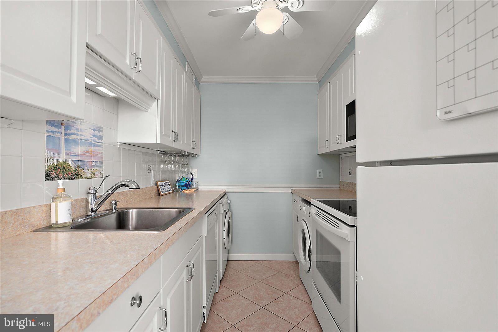 11603 Seaward Road, Unit 6 Ocean City, MD 21842 - Photo 7 of 43 a kitchen with a sink cabinets and stainless steel appliances