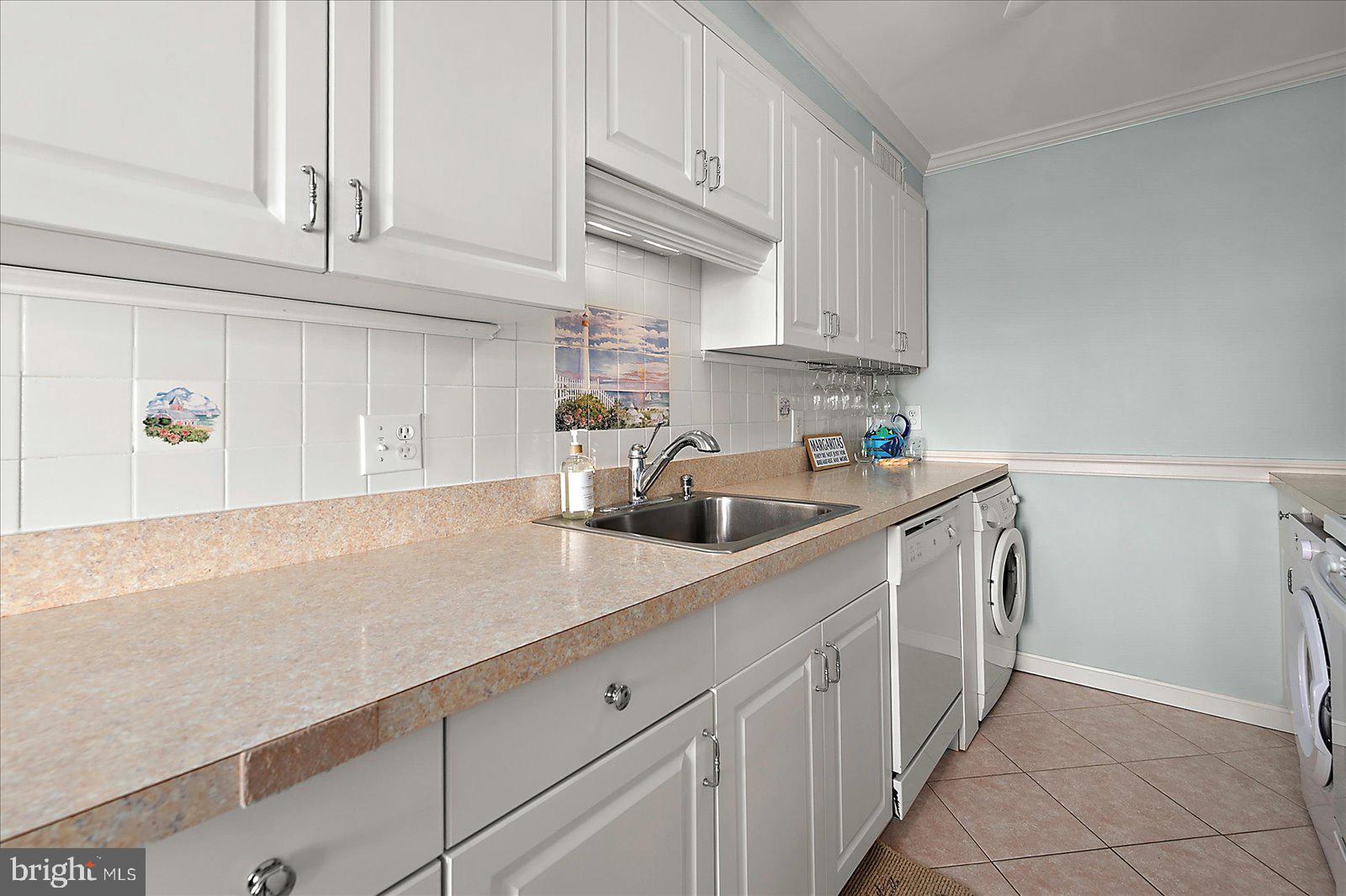 11603 Seaward Road, Unit 6 Ocean City, MD 21842 - Photo 9 of 43 a kitchen with stainless steel appliances granite countertop a sink dishwasher stove and cabinets