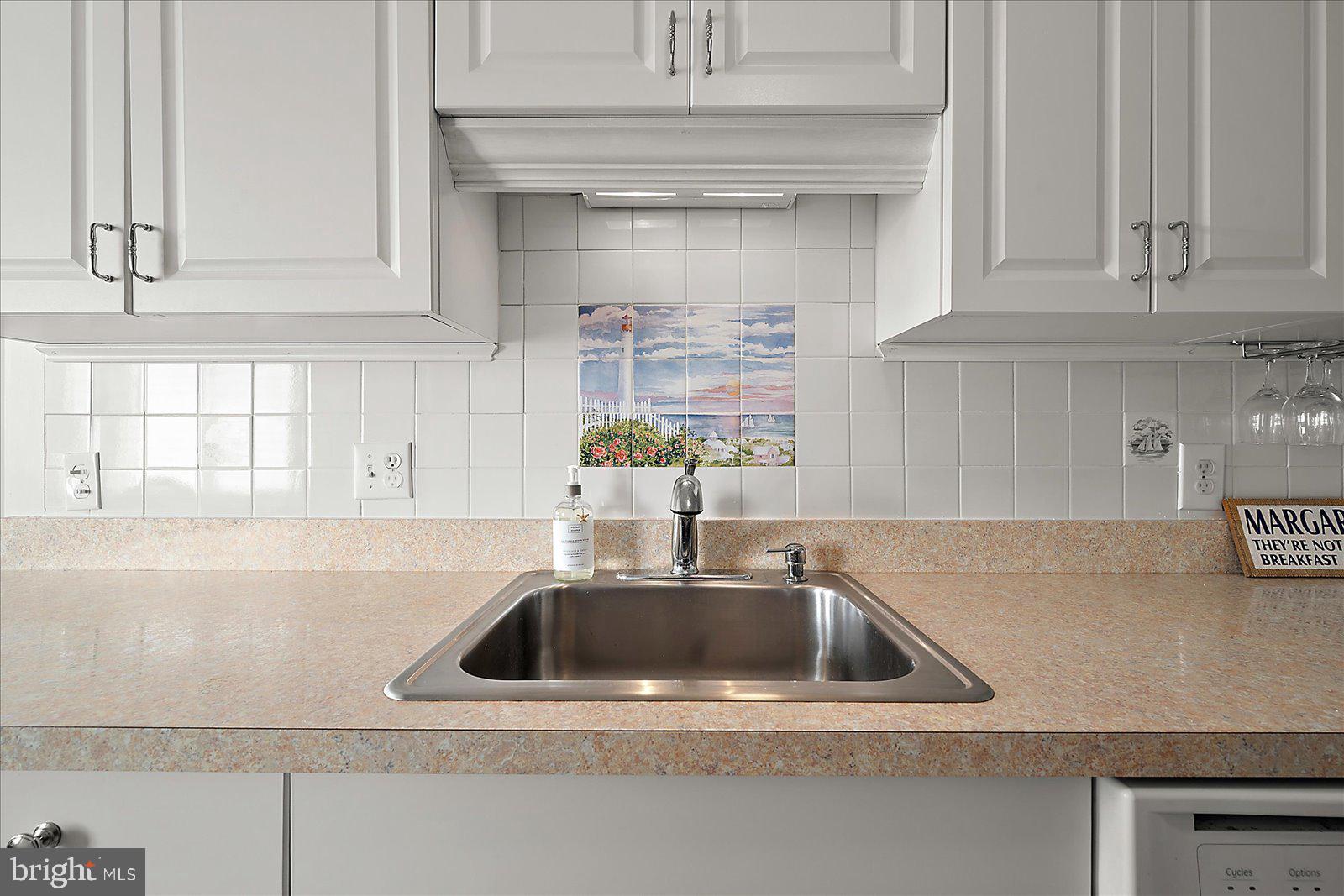 11603 Seaward Road, Unit 6 Ocean City, MD 21842 - Photo 10 of 43 a kitchen with a sink and cabinets