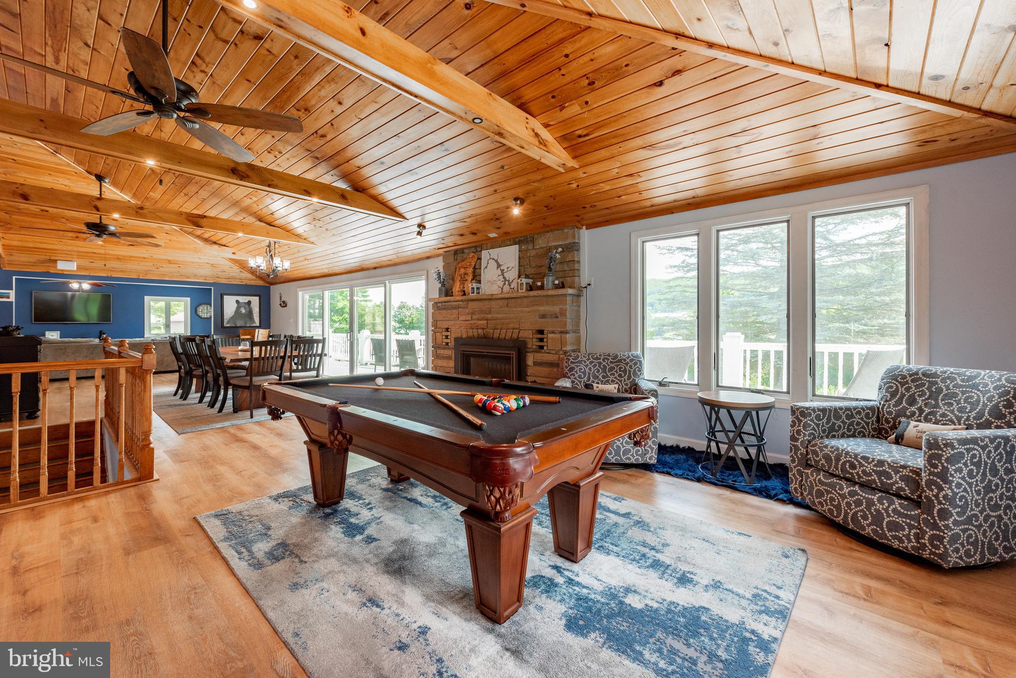 926 Marsh Hill Road McHenry, MD 21541 - Photo 21 of 70 a living room with furniture a table and chairs with wooden floor