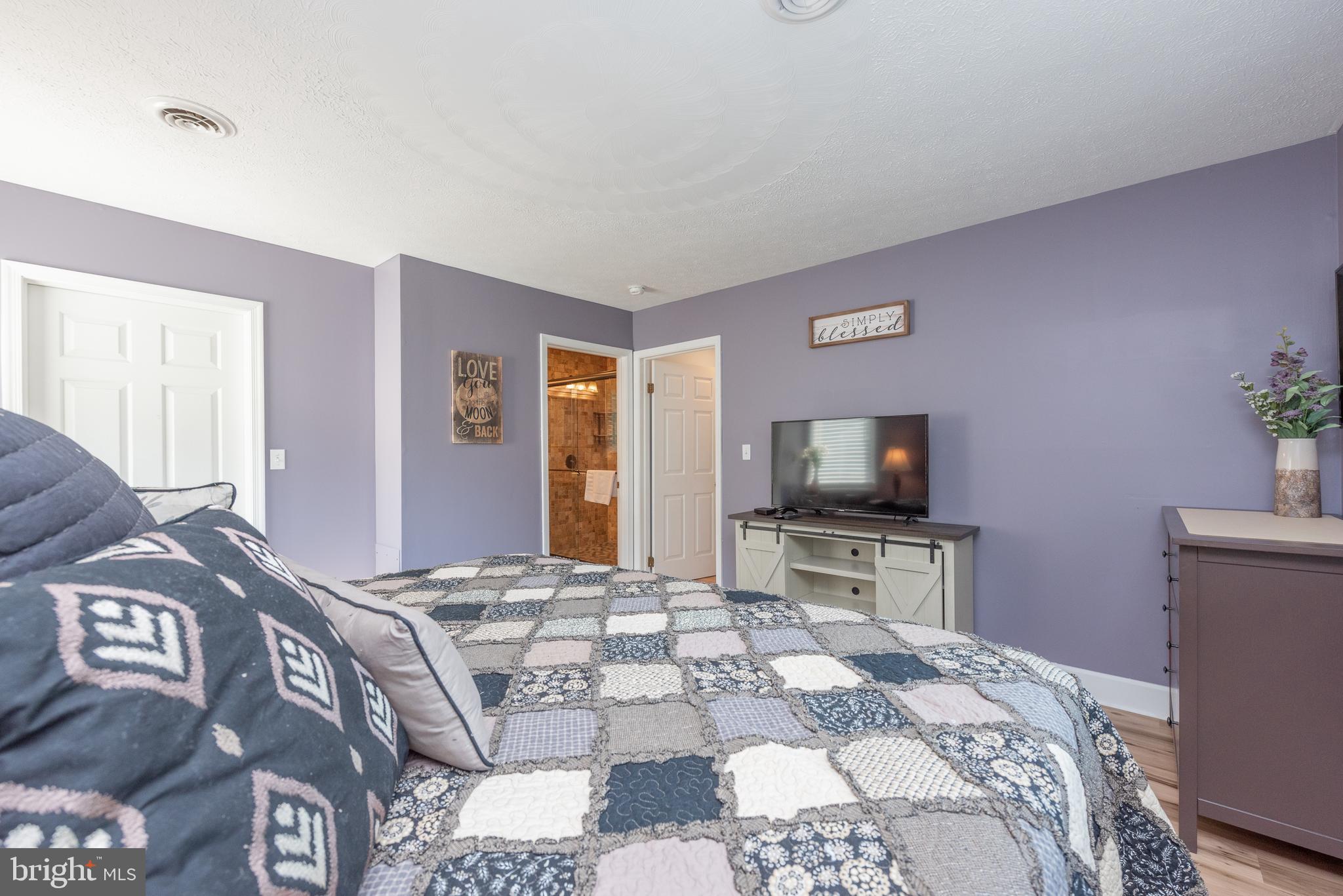 926 Marsh Hill Road McHenry, MD 21541 - Photo 23 of 70 a bedroom with a bed and a flat screen tv