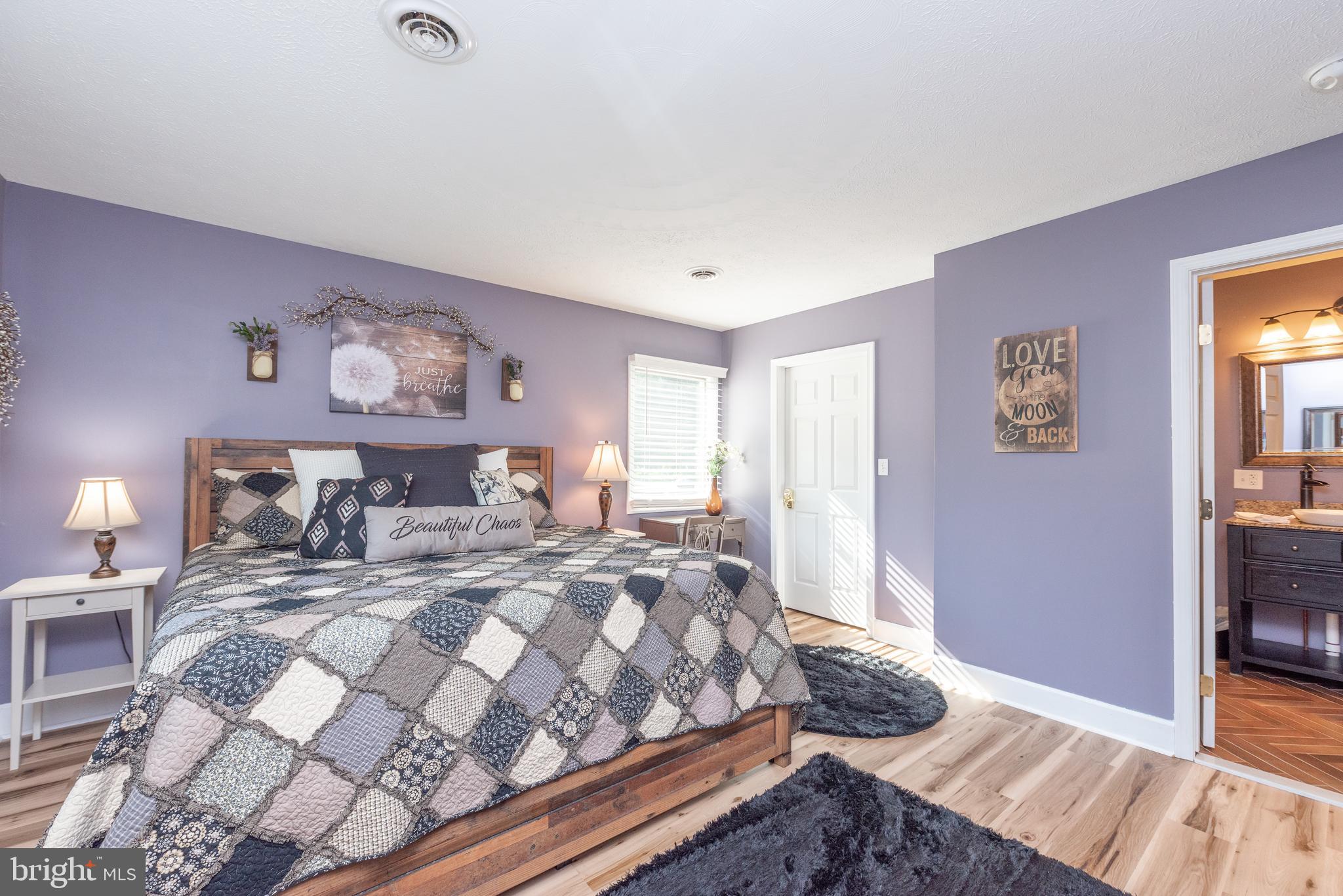 926 Marsh Hill Road McHenry, MD 21541 - Photo 27 of 70 a bedroom with a large bed and a dresser