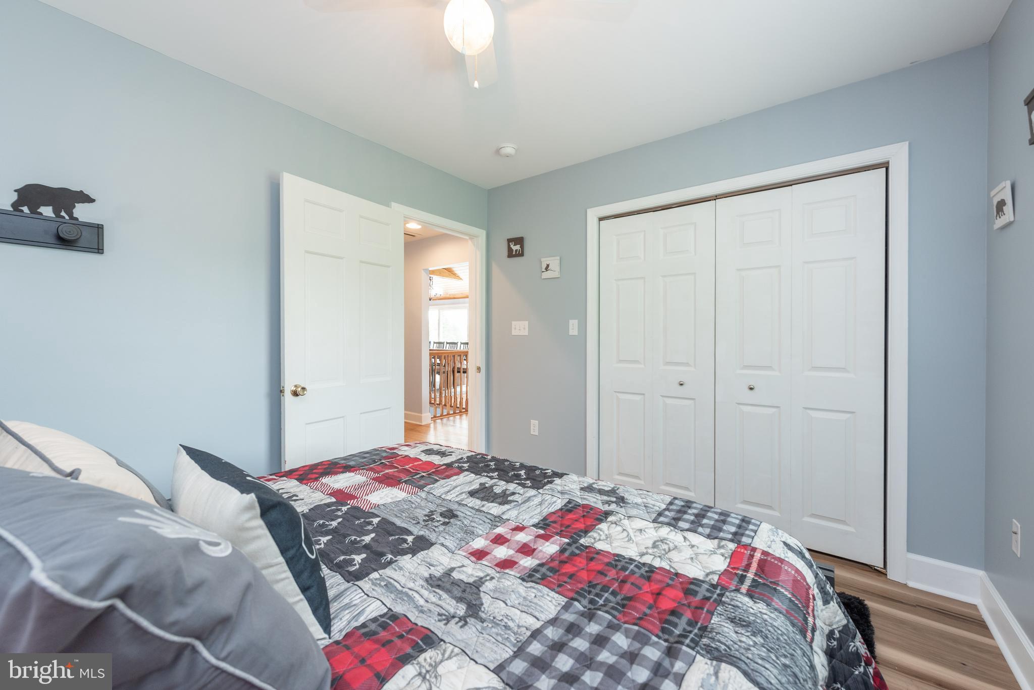 926 Marsh Hill Road McHenry, MD 21541 - Photo 30 of 70 a bedroom with a bed and a chandelier