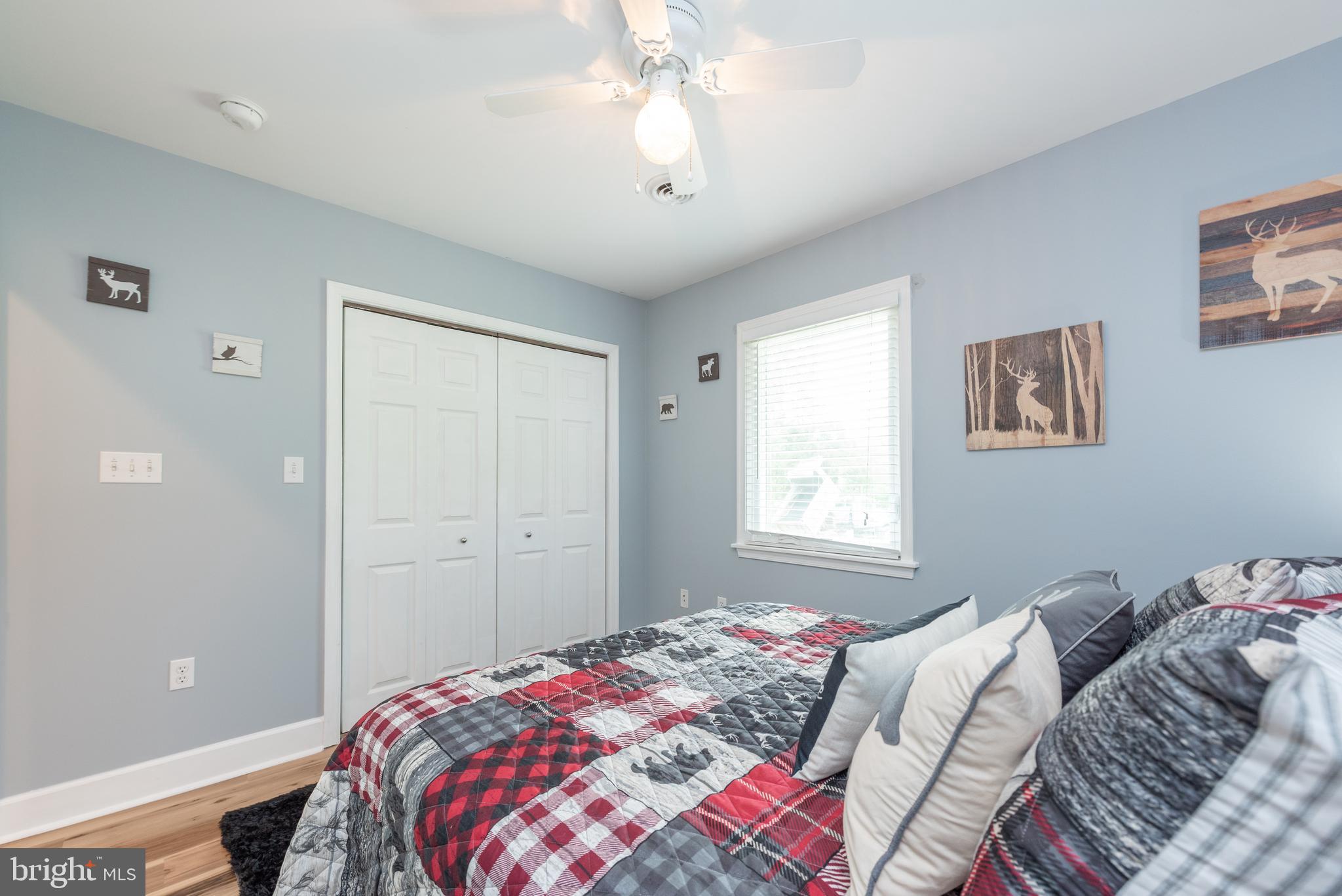 926 Marsh Hill Road McHenry, MD 21541 - Photo 31 of 70 a bedroom with a bed and a chandelier