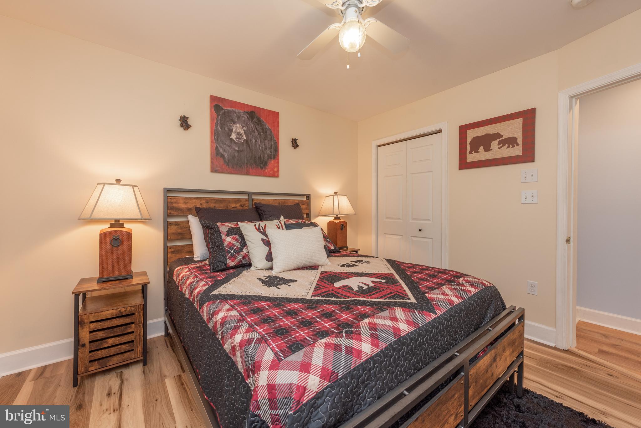 926 Marsh Hill Road McHenry, MD 21541 - Photo 34 of 70 a bedroom with a bed and a chandelier