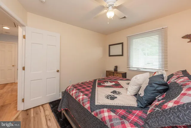 a bedroom with a bed and a painting on the wall