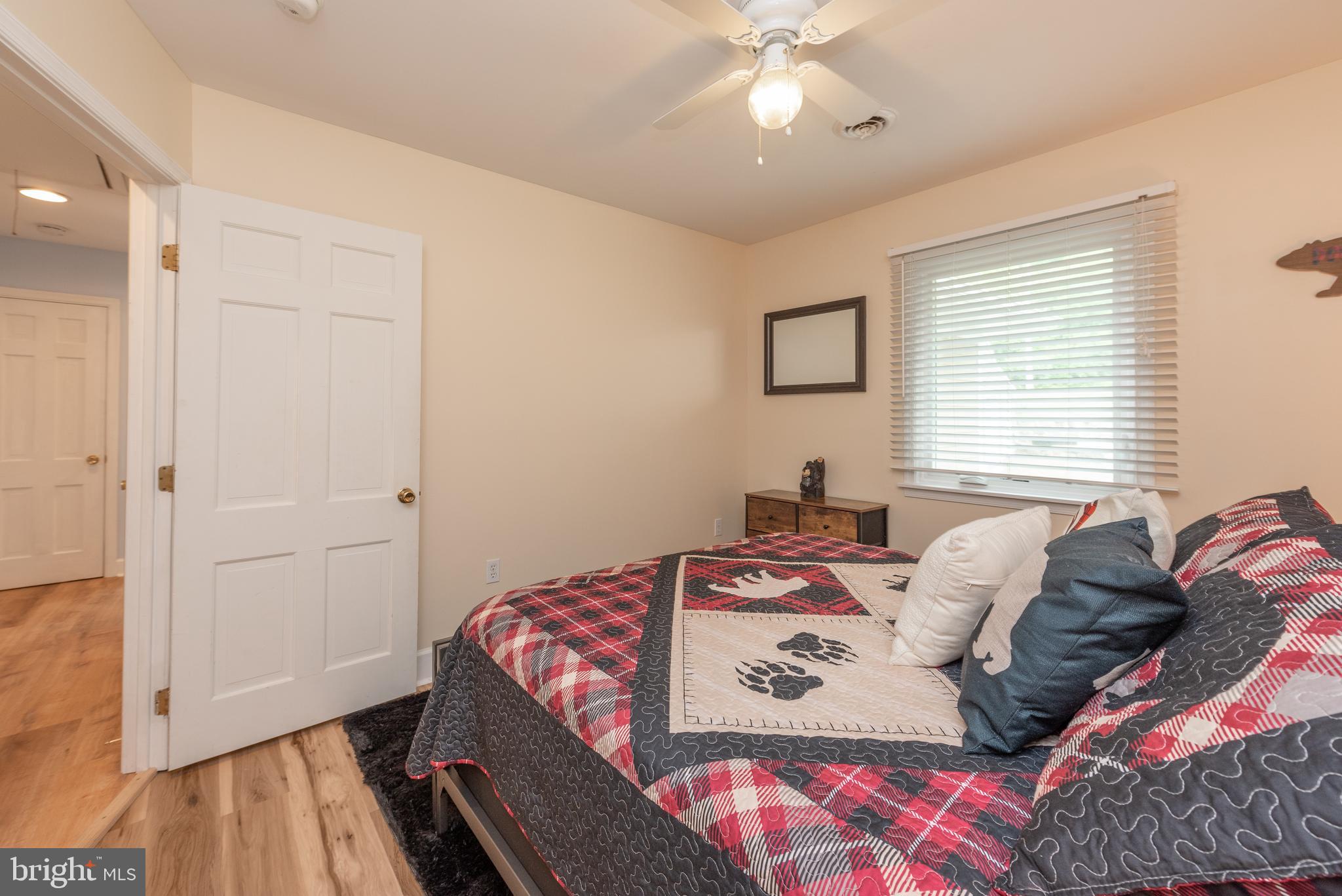 926 Marsh Hill Road McHenry, MD 21541 - Photo 36 of 70 a bedroom with a bed and a chandelier