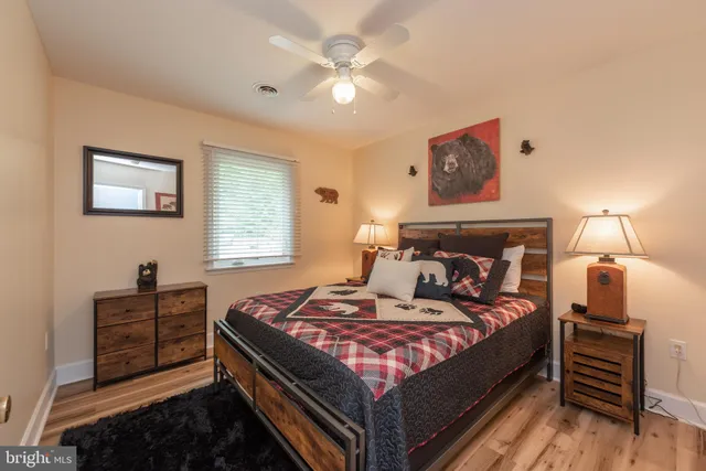 a bedroom with a large bed and a lamp