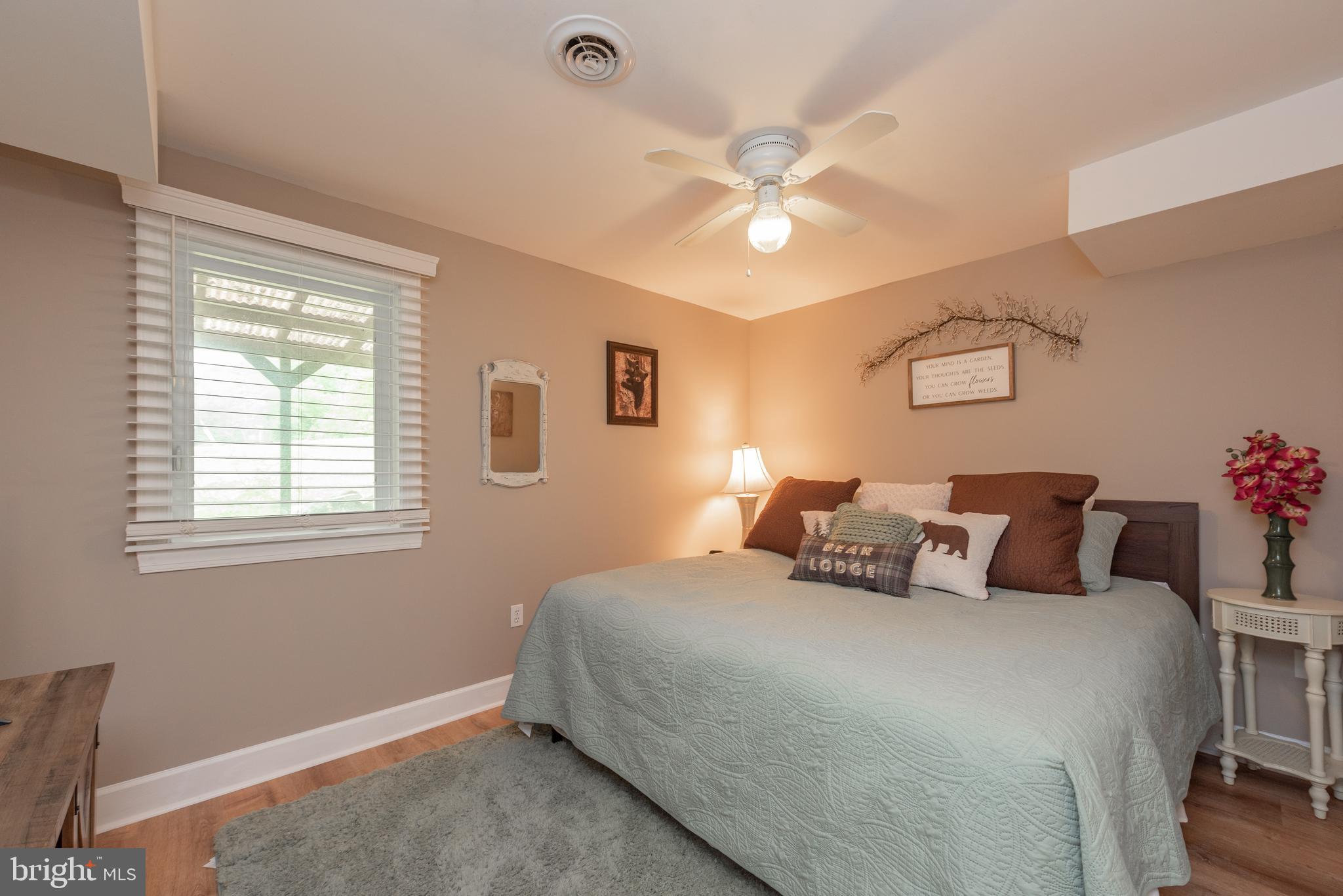 926 Marsh Hill Road McHenry, MD 21541 - Photo 47 of 70 a bedroom with a large bed and a chandelier