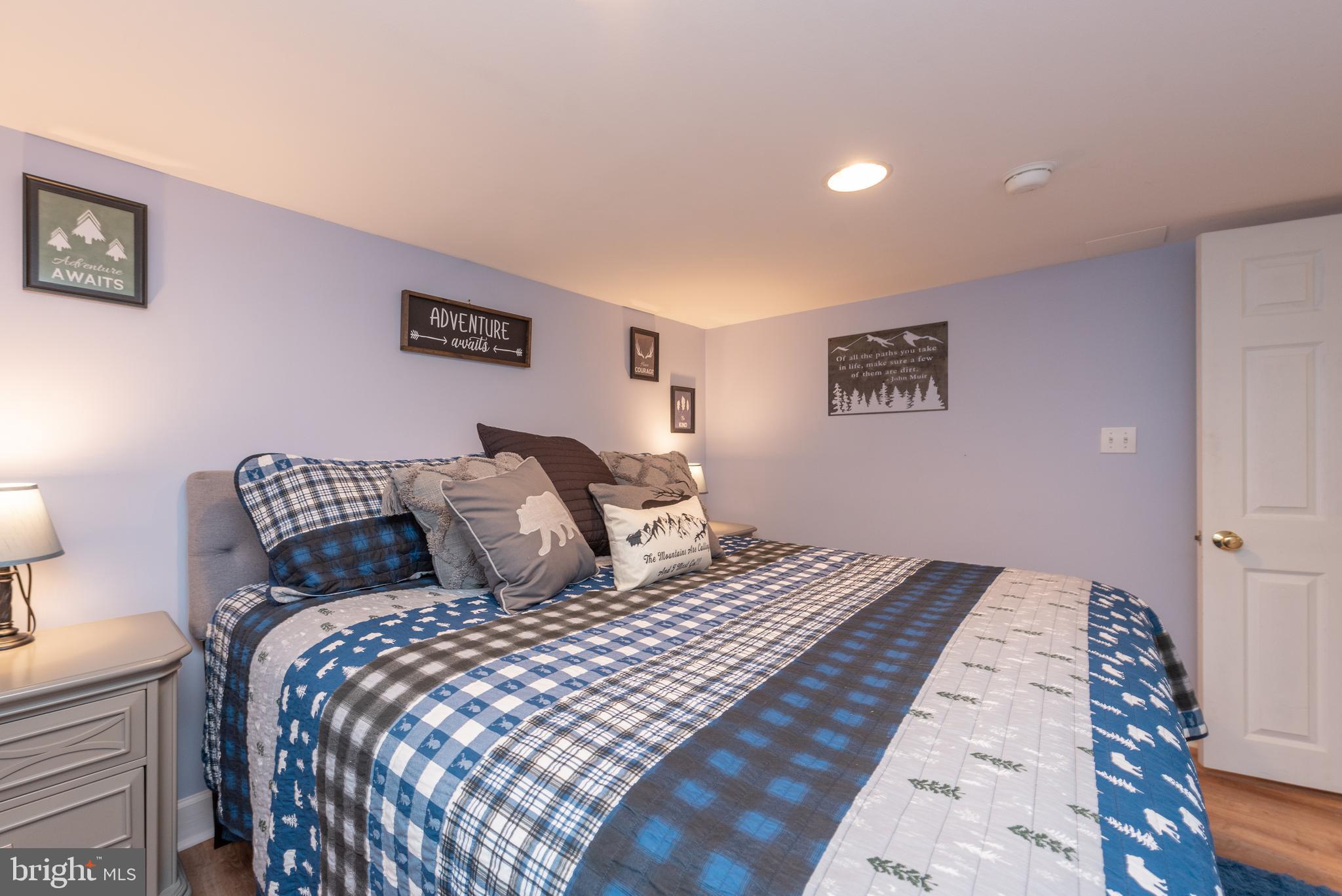 926 Marsh Hill Road McHenry, MD 21541 - Photo 49 of 70 a bedroom with a large bed and a lamp