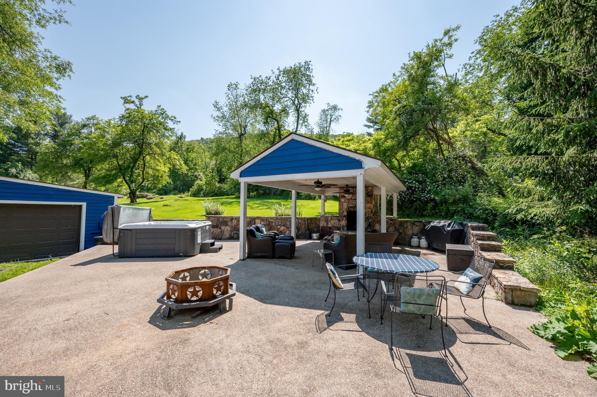 926 Marsh Hill Road McHenry, MD 21541 - Photo 58 of 70 a view of a patio with table and chairs potted plants with wooden fence
