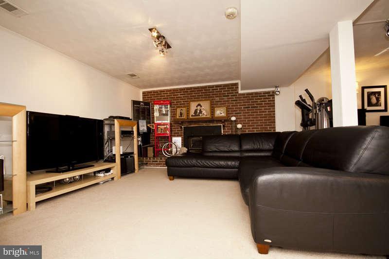 7758 Telegraph Road Severn, MD 21144 - Photo 14 of 29 a living room with furniture and a flat screen tv