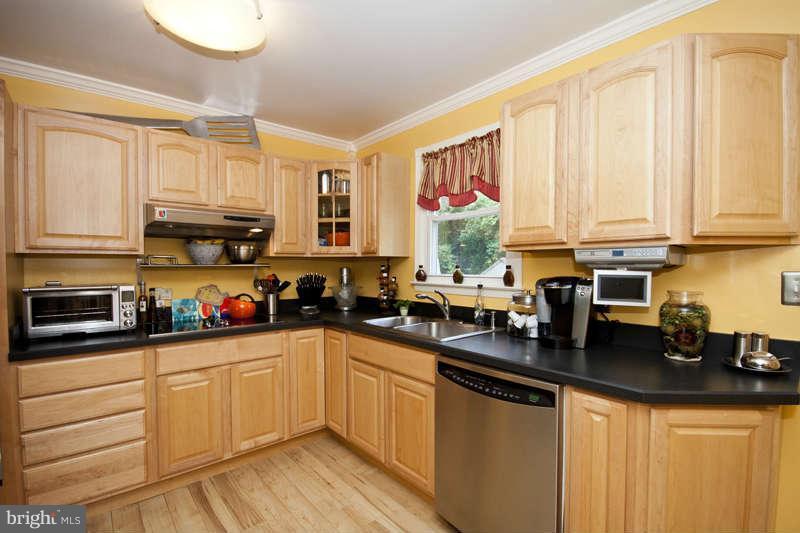 7758 Telegraph Road Severn, MD 21144 - Photo 5 of 29 a kitchen with stainless steel appliances granite countertop a sink a stove and cabinets