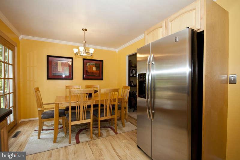 7758 Telegraph Road Severn, MD 21144 - Photo 8 of 29 a kitchen with a refrigerator and chairs