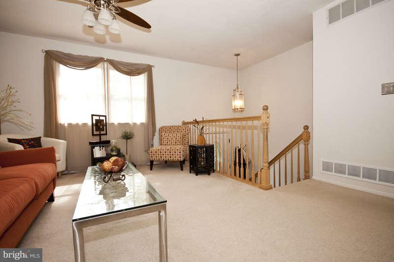 7758 Telegraph Road Severn, MD 21144 - Photo 10 of 29 a living room with furniture fireplace and a large window