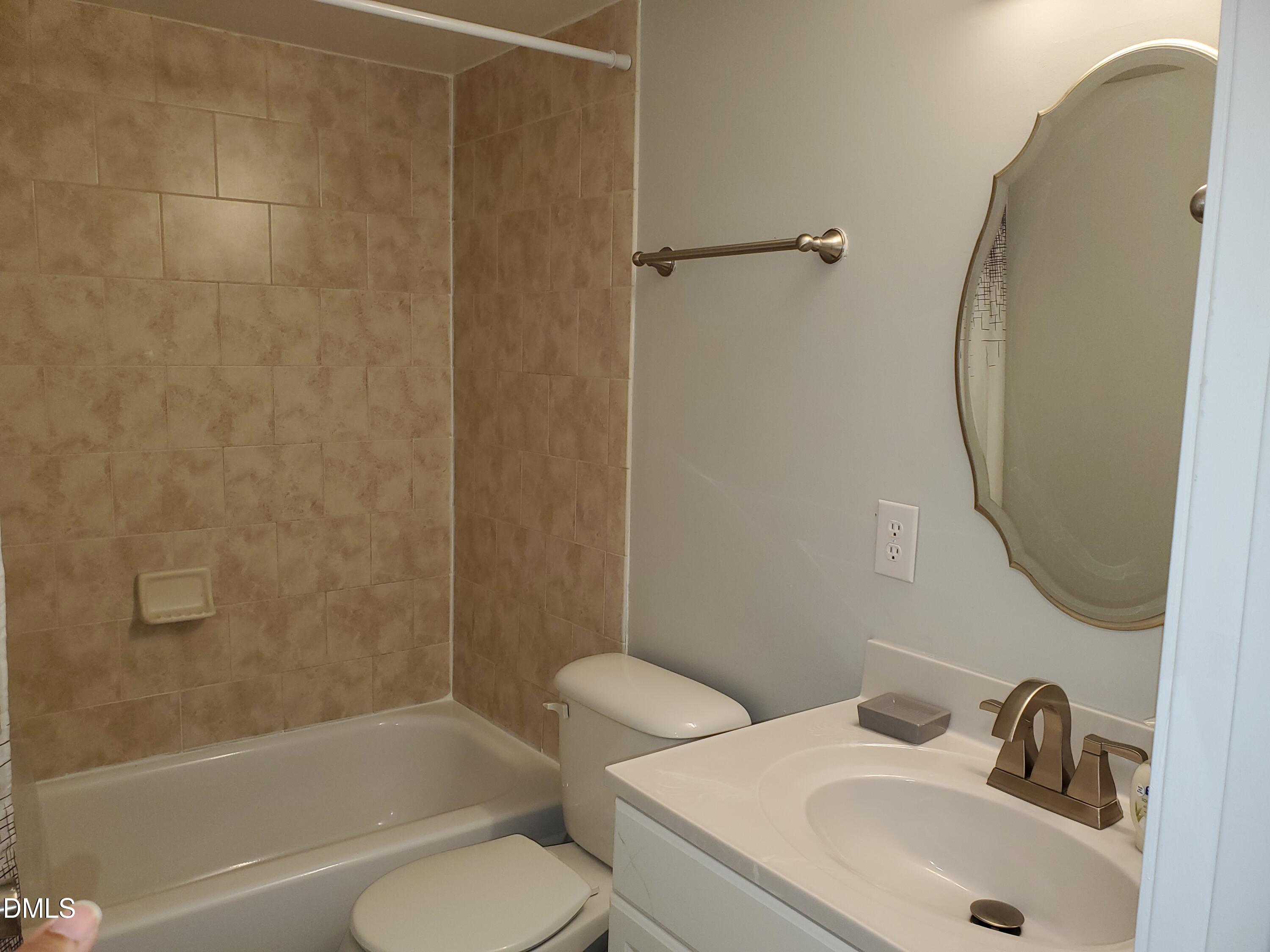 1295 Schaub Drive, Unit C Raleigh, NC 27606 - Photo 14 of 15 a bathroom with a sink toilet and shower