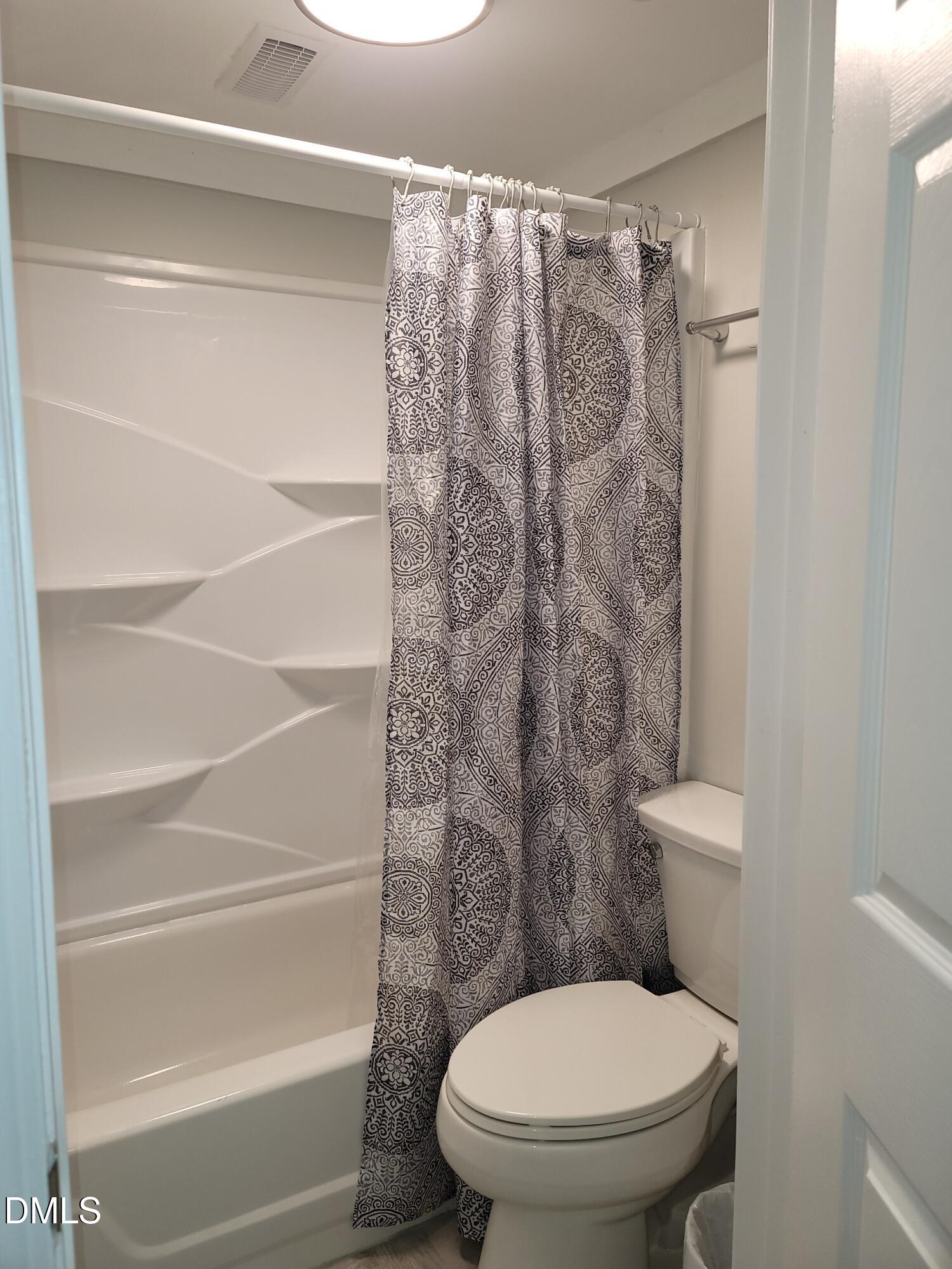 1295 Schaub Drive, Unit C Raleigh, NC 27606 - Photo 15 of 15 a white toilet sitting next to a shower