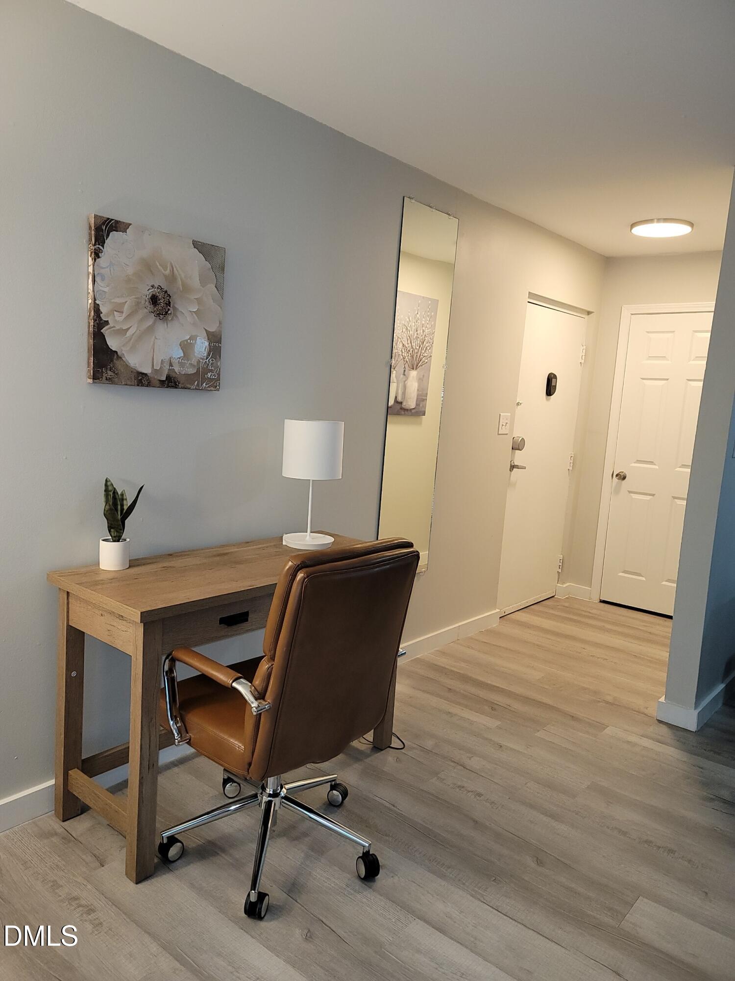 1295 Schaub Drive, Unit C Raleigh, NC 27606 - Photo 2 of 15 a view of a workspace with furniture and wooden floor