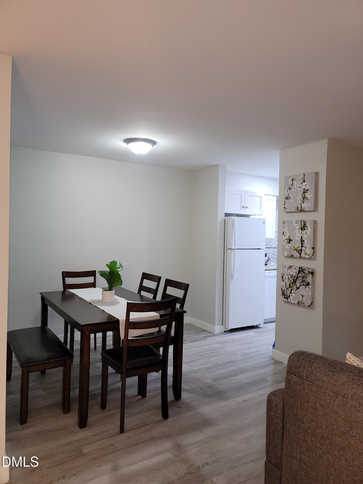 1295 Schaub Drive, Unit C Raleigh, NC 27606 - Photo 3 of 15 a workspace with furniture and wooden floor
