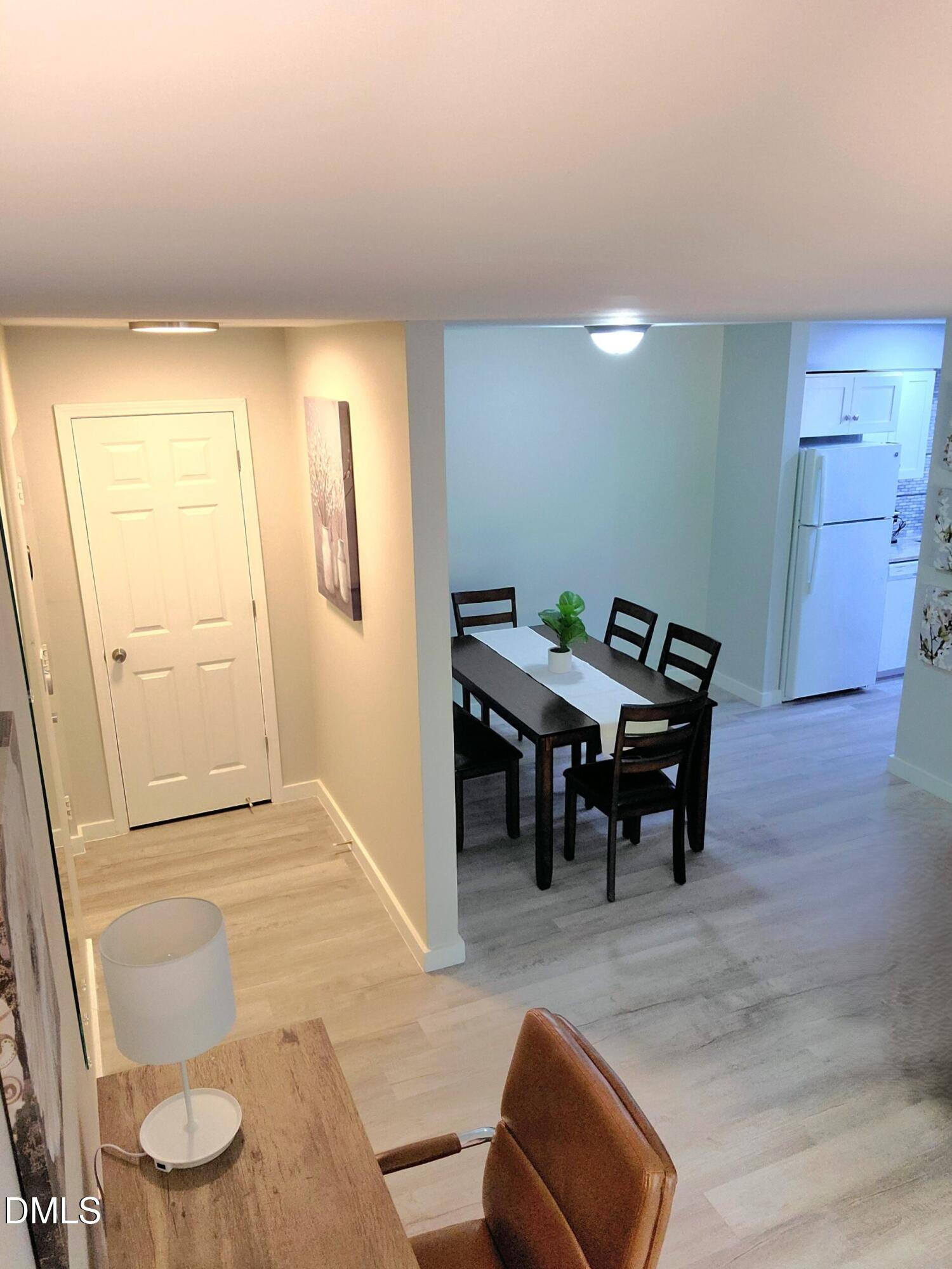 1295 Schaub Drive, Unit C Raleigh, NC 27606 - Photo 5 of 15 a living room with furniture and a dining table