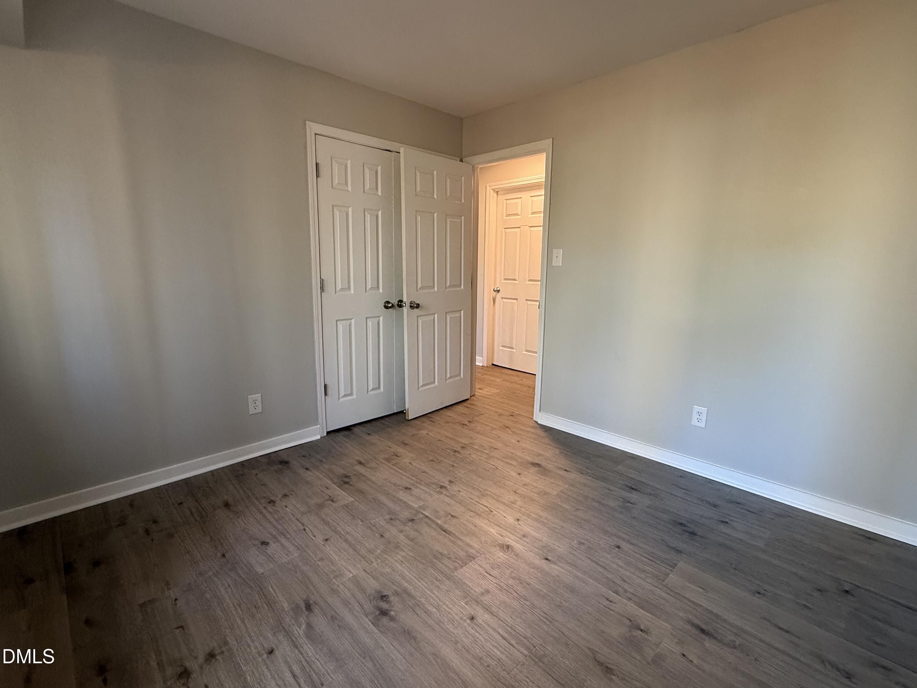 1295 Schaub Drive, Unit C Raleigh, NC 27606 - Photo 10 of 15 a view of an empty room with wooden floor