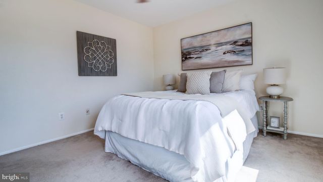 a bedroom with a bed and a wall painting