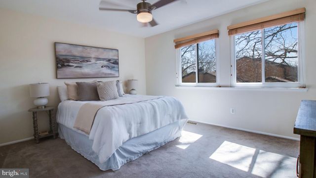 a spacious bedroom with a bed and a window