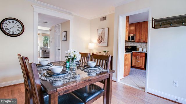 a dining room with furniture and wooden floor