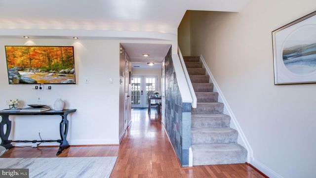 a view of a living room with furniture and wooden floor