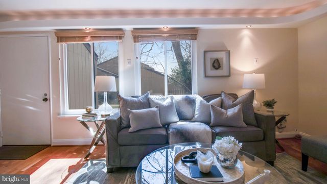 a living room with furniture and a lamp