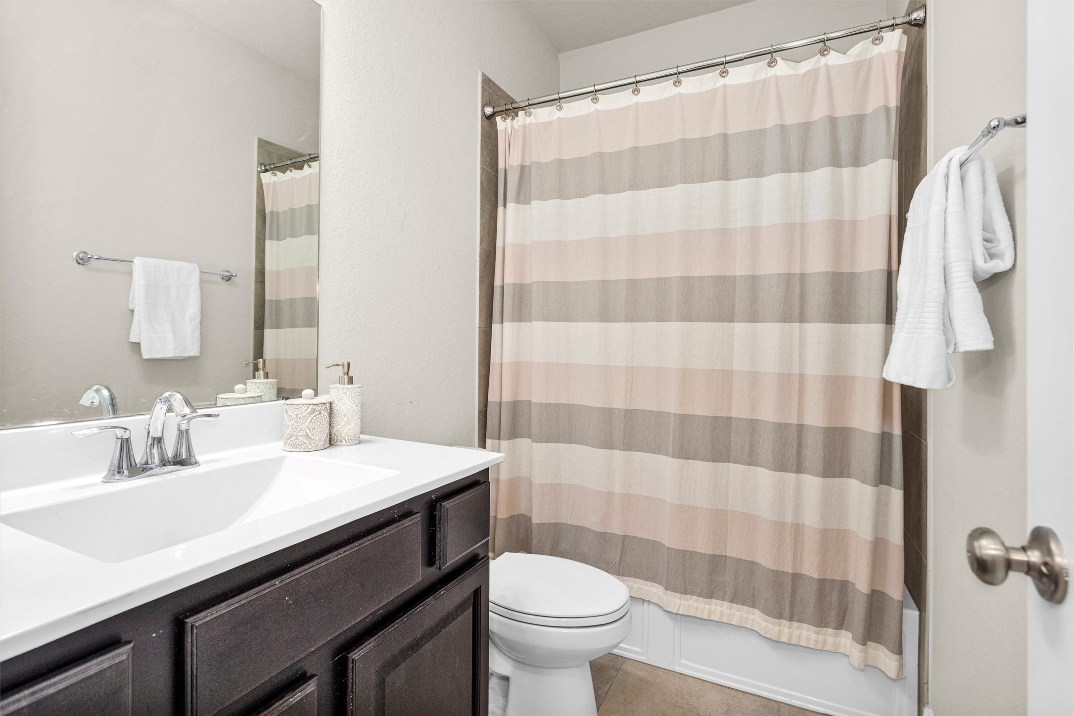 3622 Lister Drive Rosharon, TX 77583 - Photo 26 of 44 a bathroom with a sink a toilet a shower curtain and a mirror